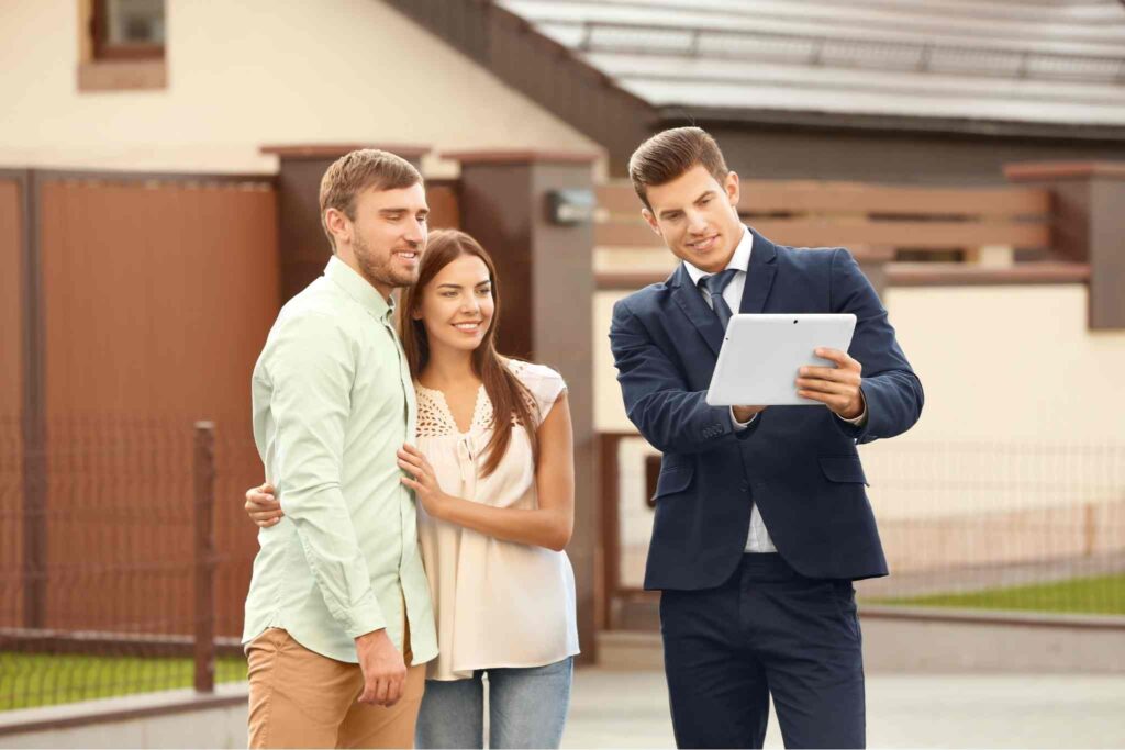 couple discussing with their real state agent